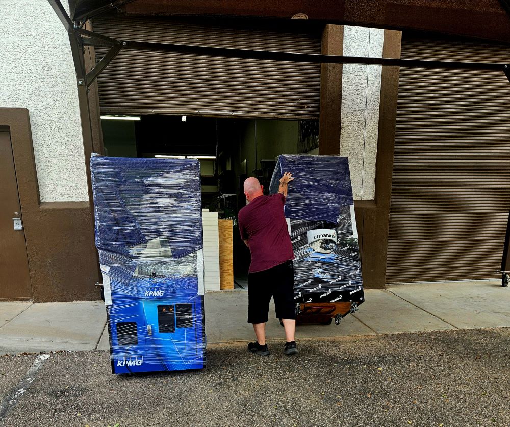 image of rolling claw machines into a truck