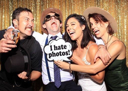 image of newly married couple having fun in the photo booth