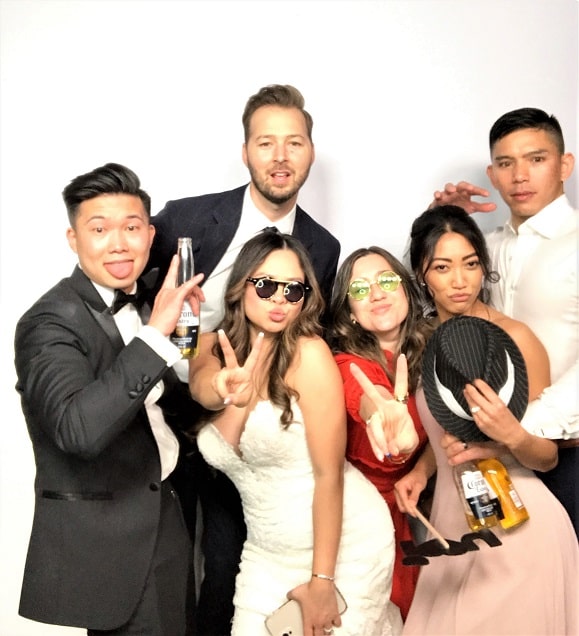 image of people and a bride posing in a photo booth