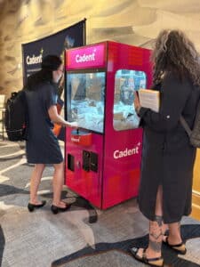 image of someone using a claw machine to extract her prize